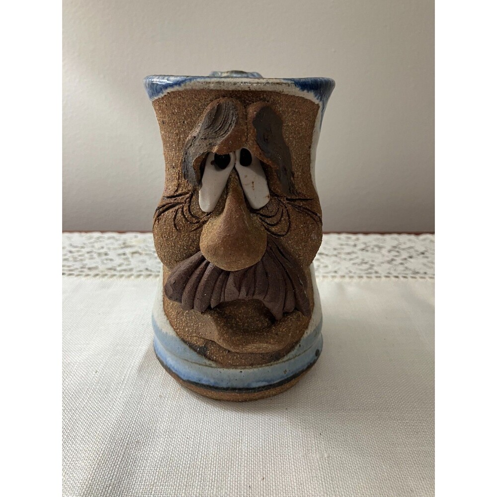 ## eBay Title **Signed Folk Art Face Mug Handmade Stoneware Blue White Glaze Whi